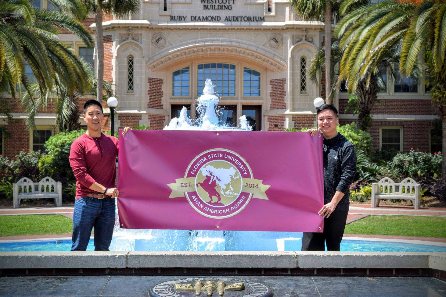 Alumni holding flag