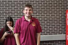 man smiling wearing a COGS collared shirt