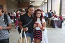 people smiling and posing near a table