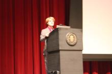 person standing behind a podium onstage