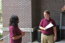two students talking in a red brick area