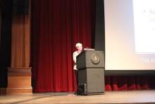 person standing behind a podium onstage