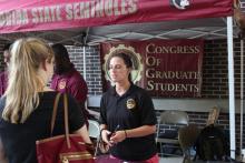 students browsing tables at an event