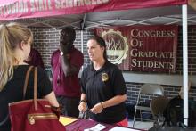 students browsing tables at an event
