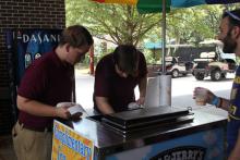 students browsing tables at an event