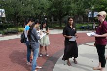students standing in front of the integration statue