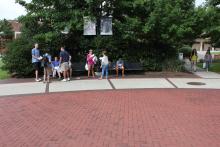students standing in front of the integration statue
