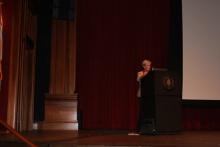 person standing behind a podium onstage
