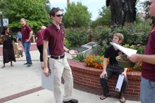 students standing in front of the integration statue