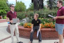 students standing in front of the integration statue
