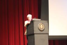 person standing behind a podium onstage