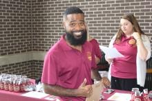man smiling wearing a COGS collared shirt