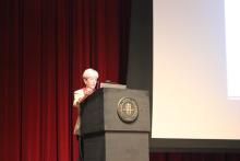 person standing behind a podium onstage