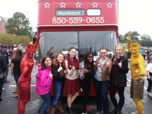 group of people standing in front of a fire truck posing with the garnet and gold guys