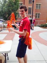 person turning toward camera and smiling, outside
