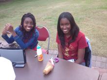 people smiling and sitting together outside