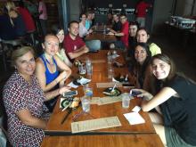 students smiling and posing at a table for eating