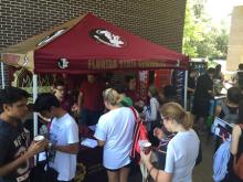 students linking up at a table 