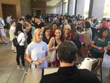 students lining up at a table during the event