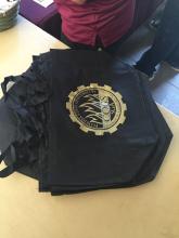 stack of bags with COGS logo