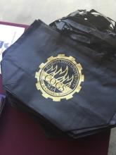 stack of bags with the COGS logo