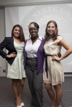 three people posing for a picture together