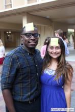 man and a woman posing together with sticky notes on their forehead