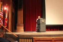 person standing behind a podium onstage