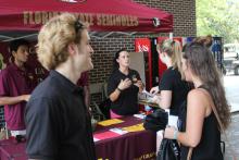 students browsing tables at an event
