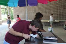 students browsing tables at an event