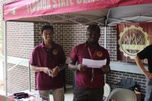 COGS students smiling under an awning