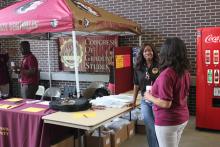 students browsing tables at an event