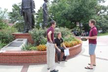 students standing in front of the integration statue