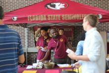 students browsing tables at an event