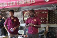 COGS students smiling under an awning