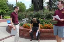 students standing in front of the integration statue