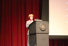 person standing behind a podium onstage
