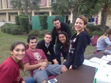 people smiling and sitting together outside