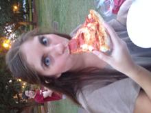 person eating a pepperoni pizza slice