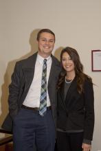 two people standing together posing