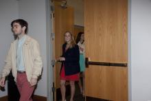 people walking through a doorway