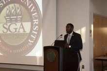 person standing behind a podium presenting