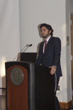 person standing behind a podium speaking