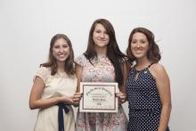 three people posing for a picture together