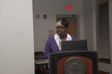 person standing behind a podium giving a presentation