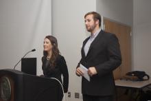 person standing behind a podium giving a presentation