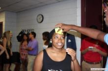 woman looking up as a sticky note is placed on her forehead