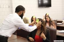 woman looking up as a sticky note is placed on her forehead