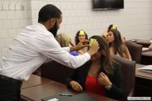 woman looking up as a sticky note is placed on her forehead