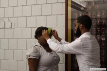 woman looking up as a sticky note is placed on her forehead